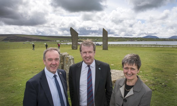 Alex Paterson, Chief Executive of Historic Environment Scotland, James Stockan, Leader of Orkney Islands Council and Carroll Buxton, Interim Chief Executive at HIE pose in front of the Stones of Stenness. 