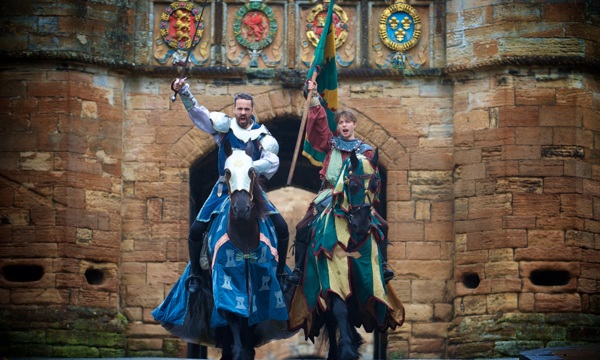Two knights on horseback pose in front of the gates to Linlithgow Palace ahead of a jousting tournament 