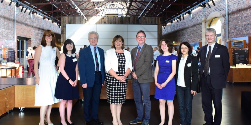 Fiona Hyslop (Cabinet Secretary for Culture, Tourism, External Affairs and Europe) poses with 4 women and 3 men inside the Engine Shed