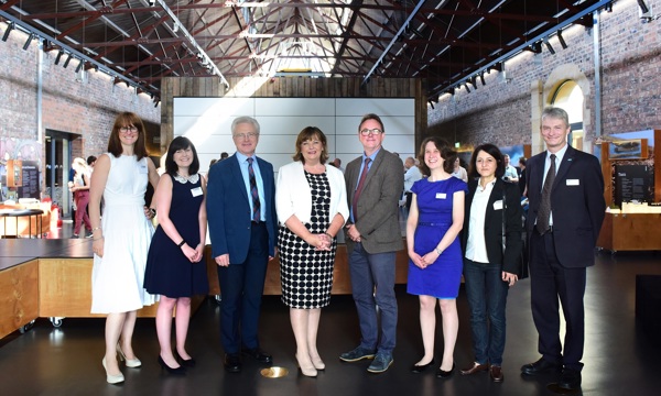 Fiona Hyslop (Cabinet Secretary for Culture, Tourism, External Affairs and Europe) poses with 4 women and 3 men inside the Engine Shed