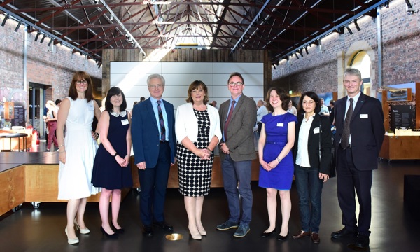 Fiona Hyslop (Cabinet Secretary for Culture, Tourism, External Affairs and Europe) poses with 4 women and 3 men inside the Engine Shed