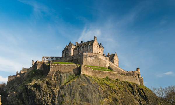 Edinburgh Castle photographed from the Princes Street Gardens to the north under a clear blue sky