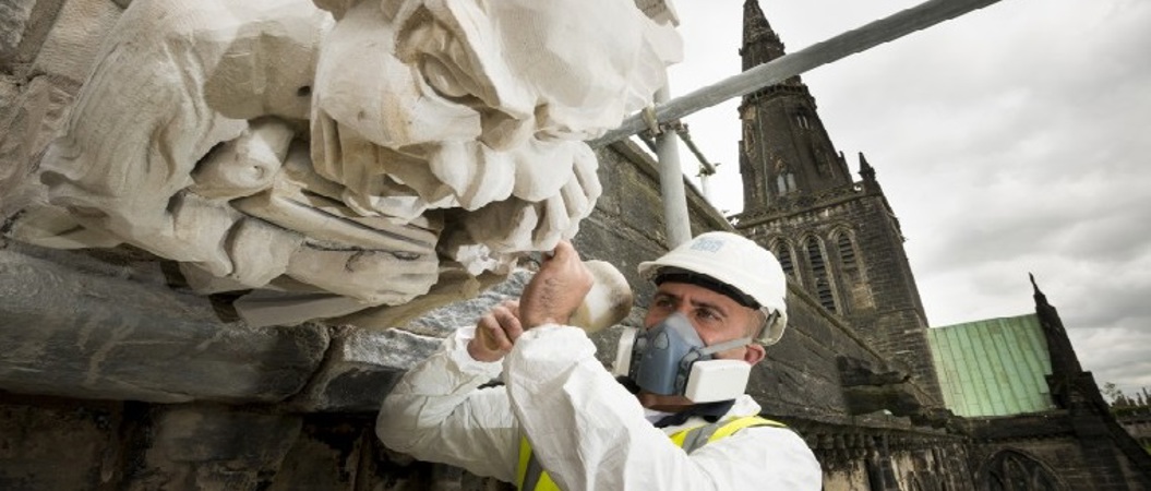 A stonemason carves a gargoyle at Glasgow Cathedral
