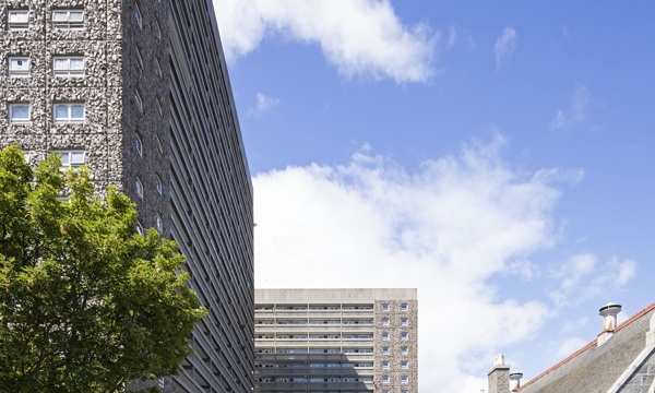 Sets of high rise flats against a blue sky