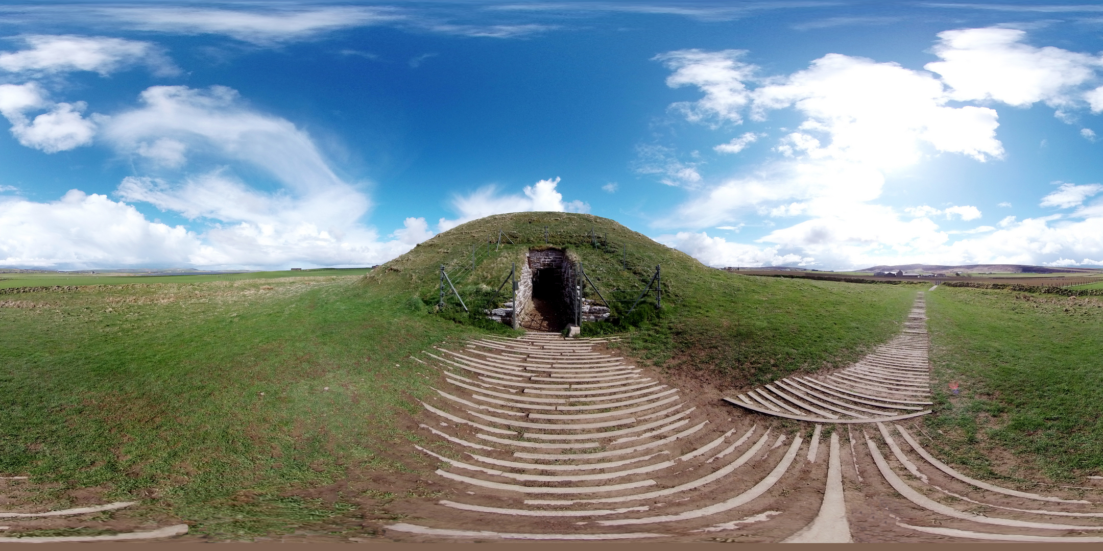 360 view of a chambered cairn with a path.