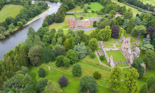 Aerial view of Dryburgh Abbey and the river tweed with lots of trees