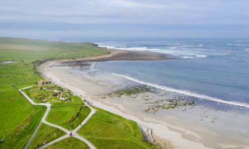 An aerial photo of Skara Brae - a historic settlement by the sea