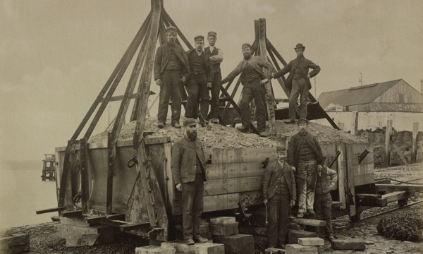 A group of workers pose for a photograph during the construction of the Forth Bridge 