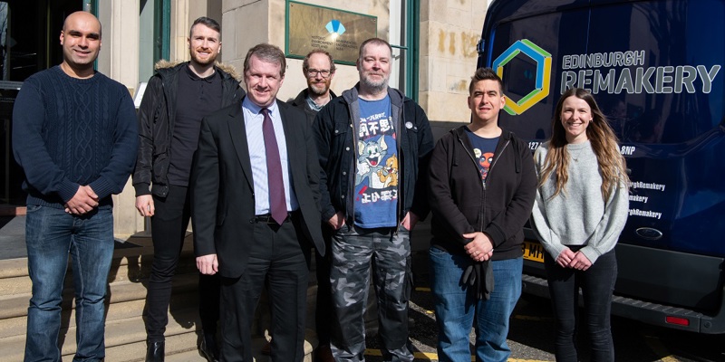 Staff from Historic Environment Scotland and the Edinburgh Remakery pose in front of Longmore House, HES headquarters, and an Edinburgh Remakery branded van ahead of a donation 