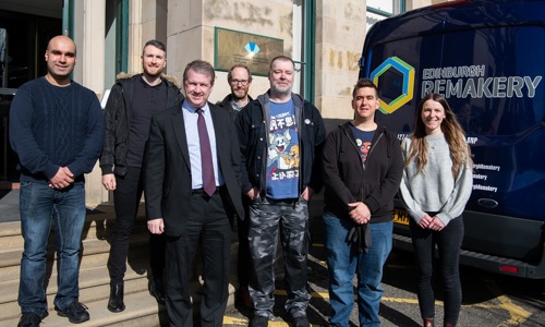 Staff from Historic Environment Scotland and the Edinburgh Remakery pose in front of Longmore House, HES headquarters, and an Edinburgh Remakery branded van ahead of a donation 