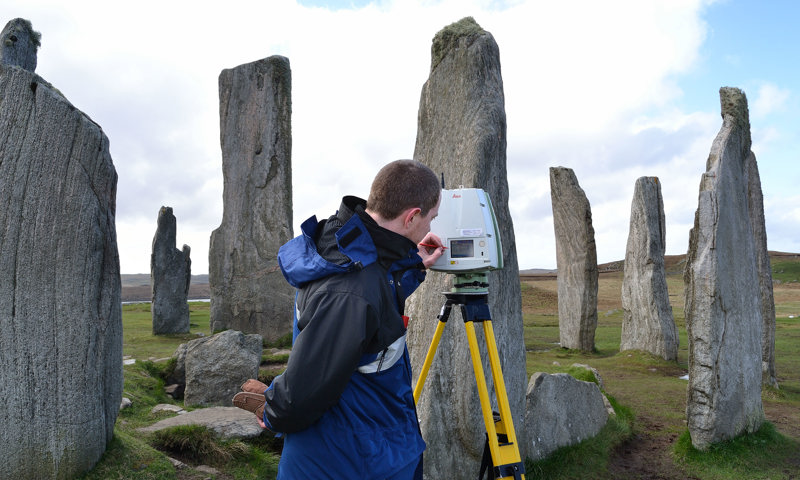 Member of staff using a laser scanner at Calanais Standing Stones