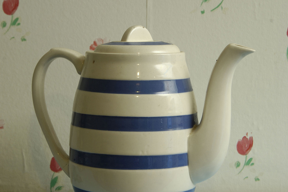 A blue and white striped teapot