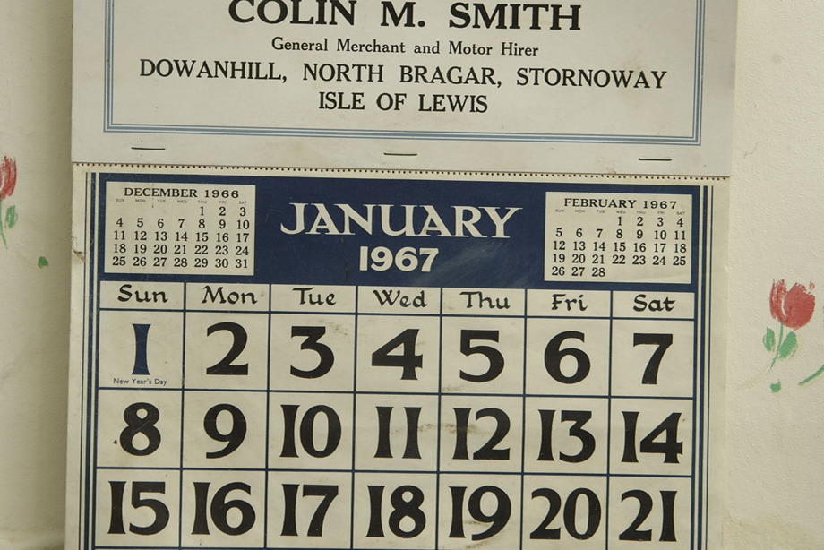 A white and blue calendar on a wall, showing January 1967