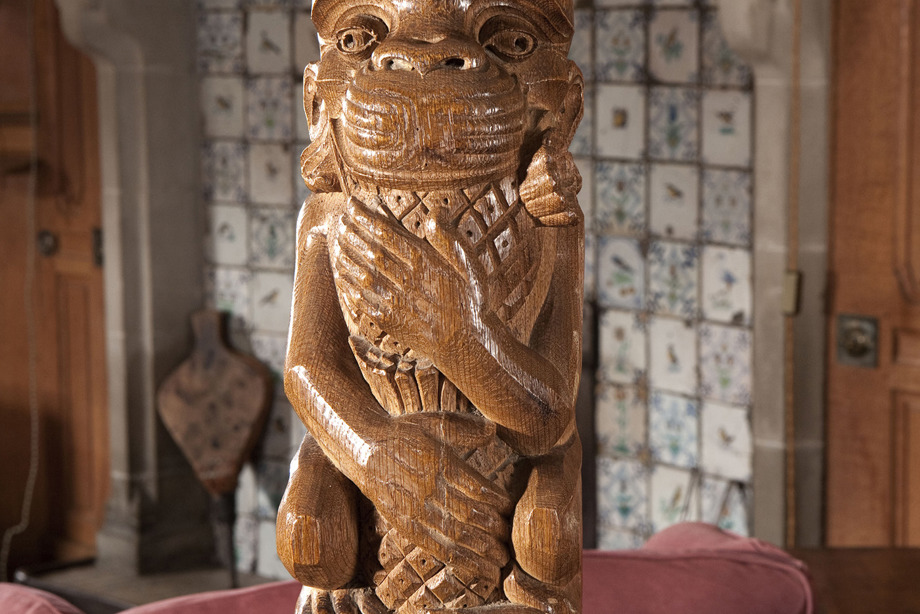 A tall, wooden pole with a monkey carved into the top