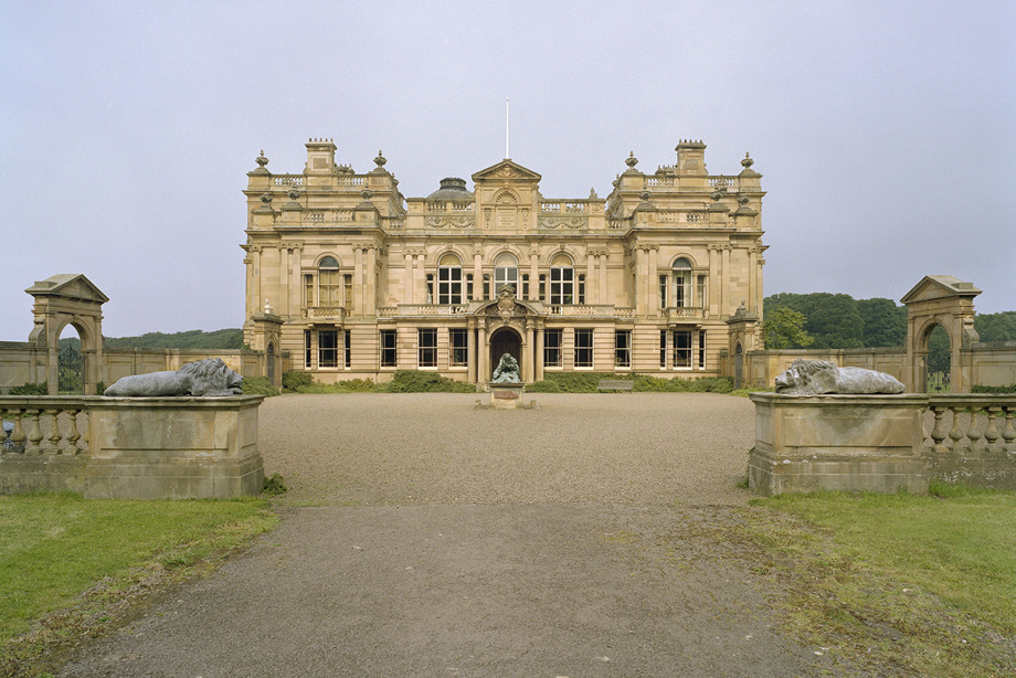 A large, stone mansion in the countryside