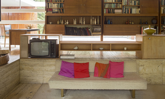 A sunken seating area, with wooden cabinets in the background