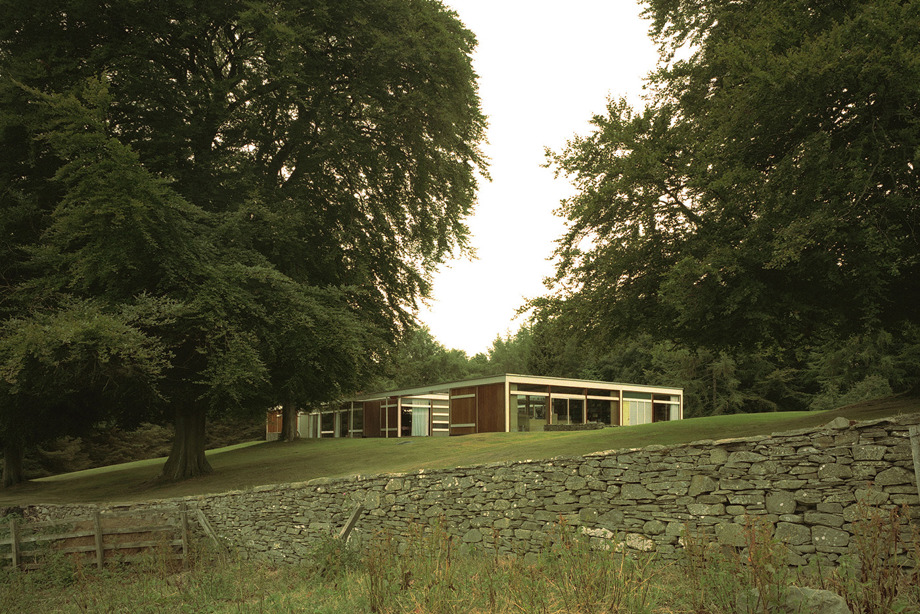 A low, square building in the countryside
