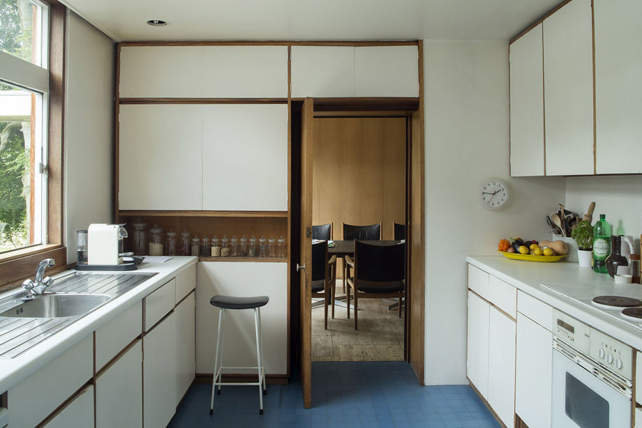 A kitchen with white and wooden units