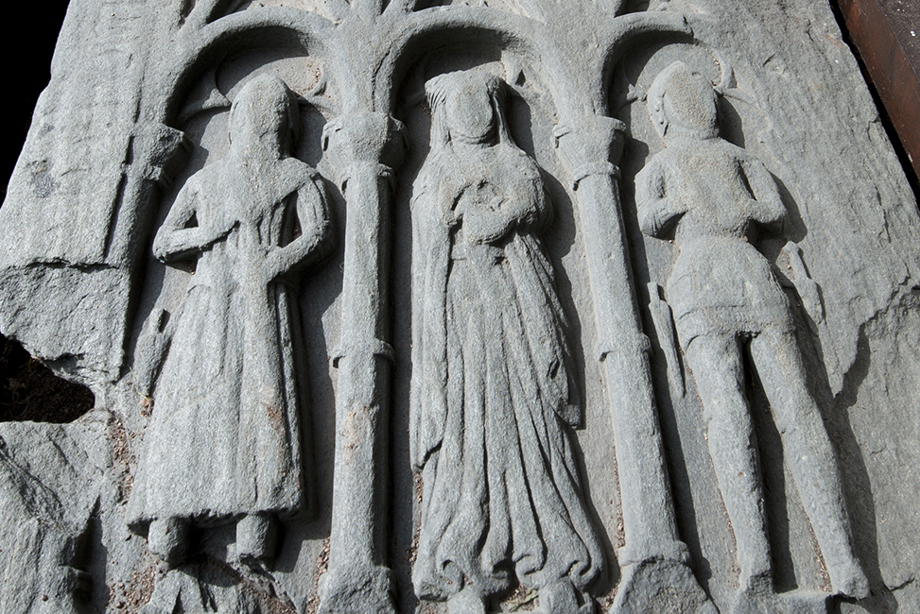 A grave slab depicting carved figures
