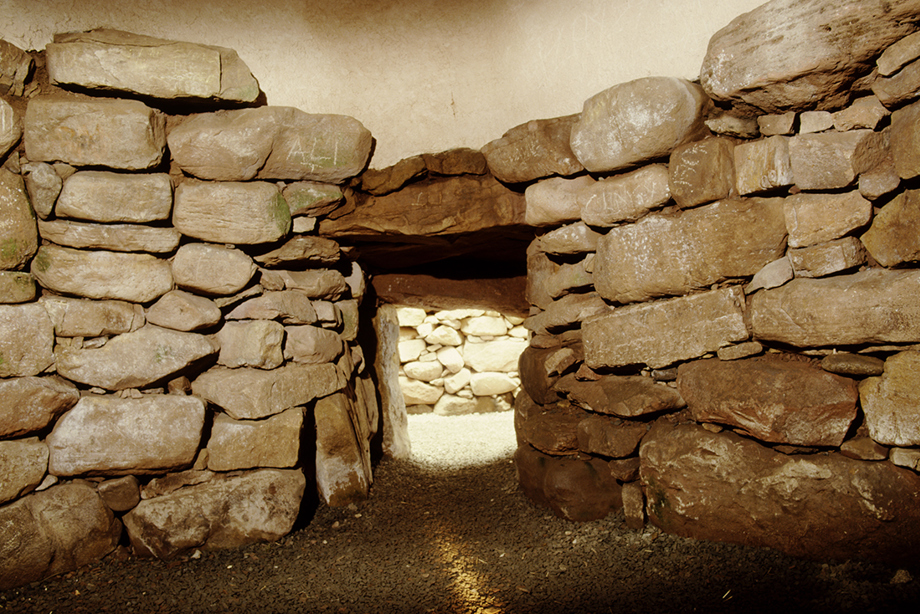 A low and narrow entrance with stone walls on either side