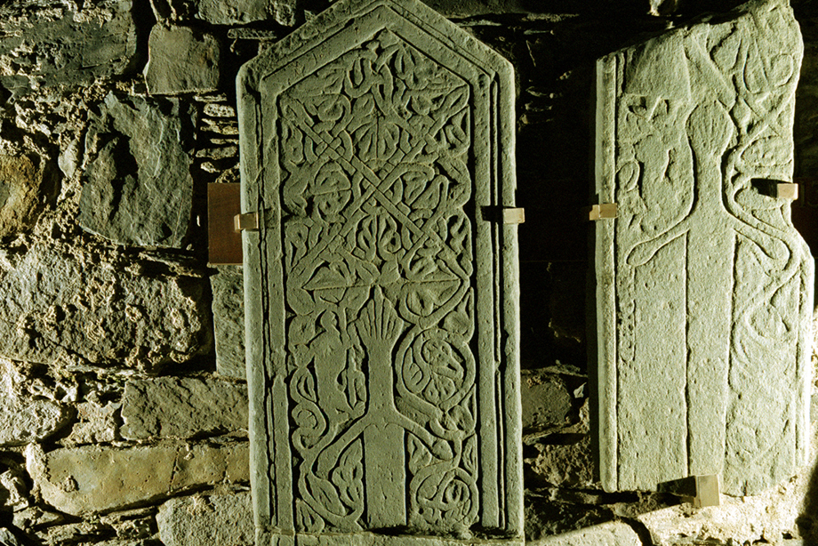 A carved stone decorated with a complex swirling pattern