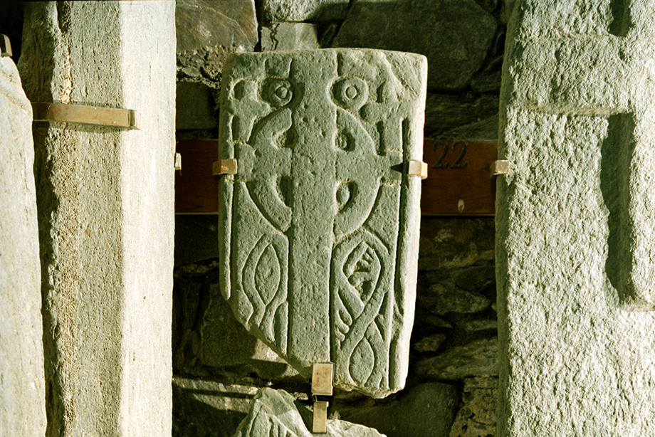 A carved stone, broken in multiple places 