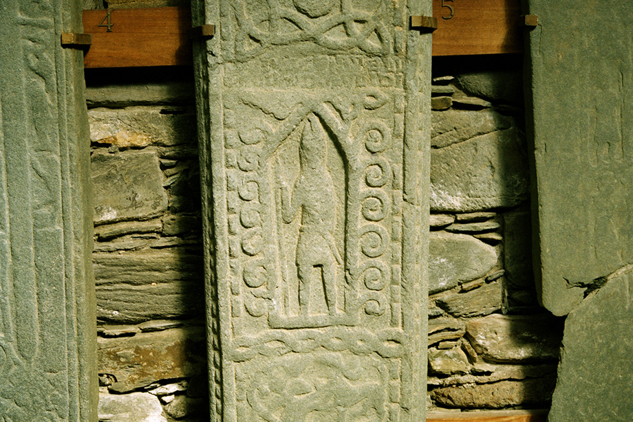 A carved stone slab depicting a person in the centre