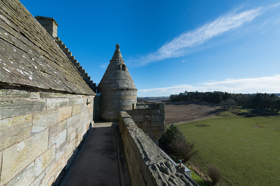 A narrow walkway along the top of a tower wall.