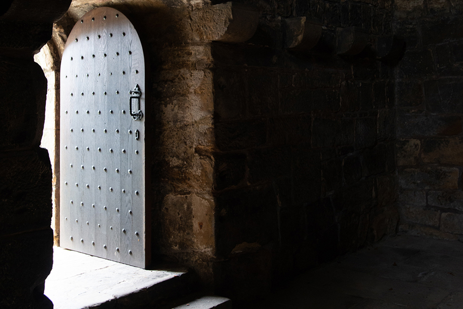 An open doorway to a stone walled room
