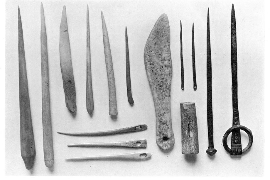 A collection of pins and needles in a black and white photograph