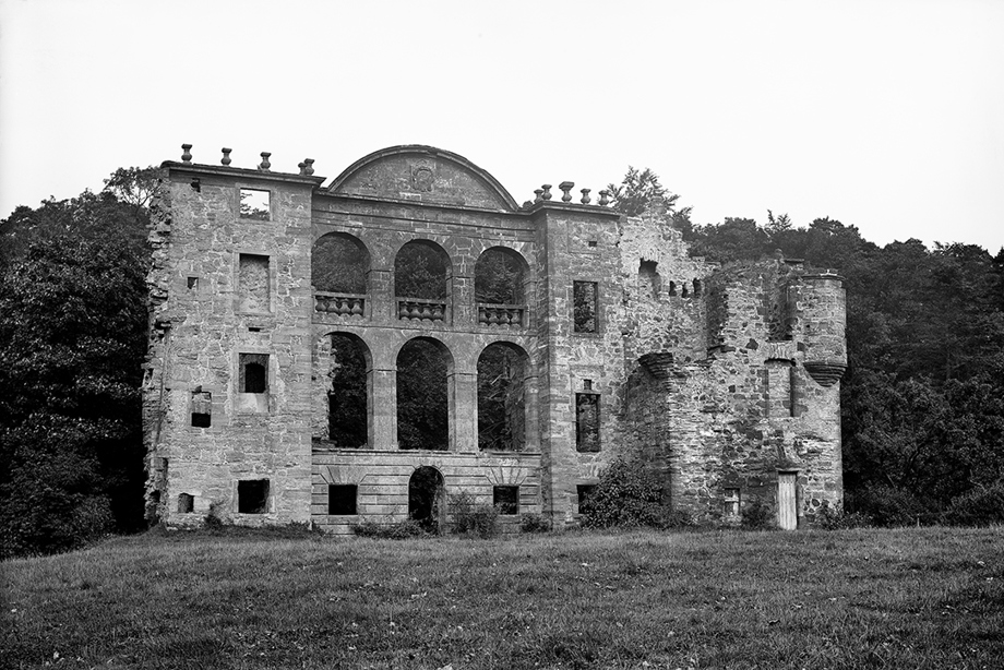 A dramatic, ruined wall with tall windows