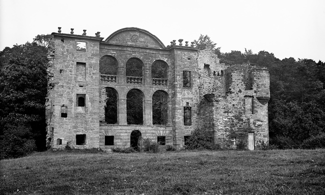 A dramatic, ruined wall with tall windows