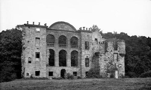 A dramatic, ruined wall with tall windows