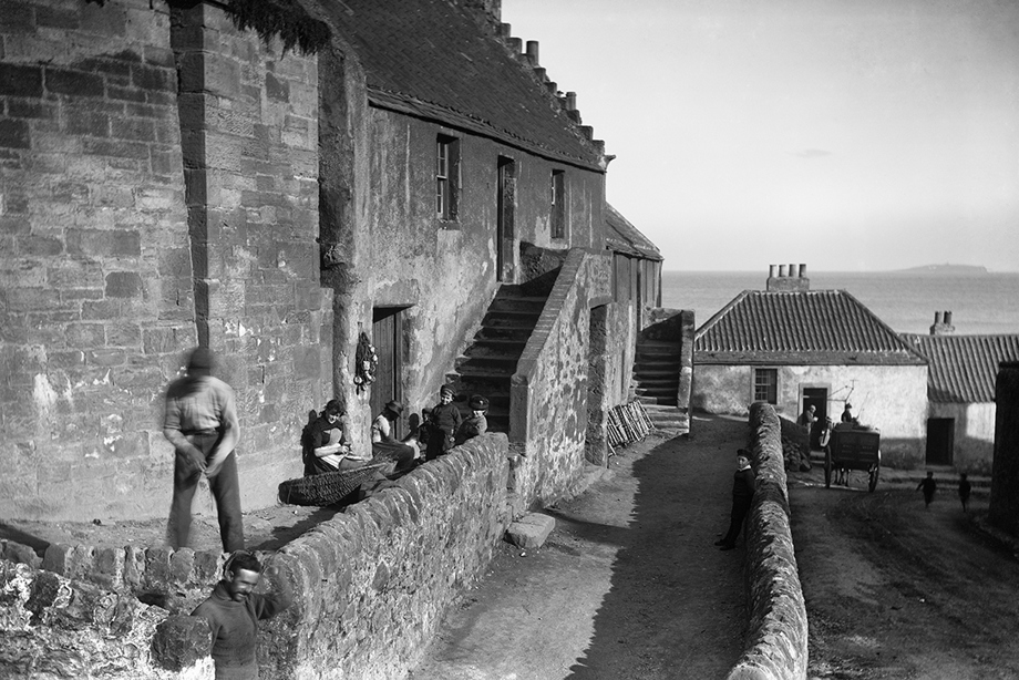 View of men working in Shoregate, with a royal castle just to the east of the burgh.