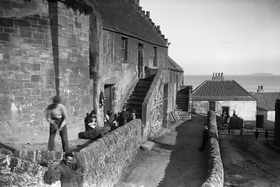 View of men working in Shoregate, with a royal castle just to the east of the burgh.