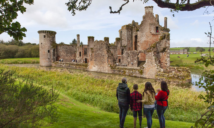 Family looking at Caerlaverock Castle