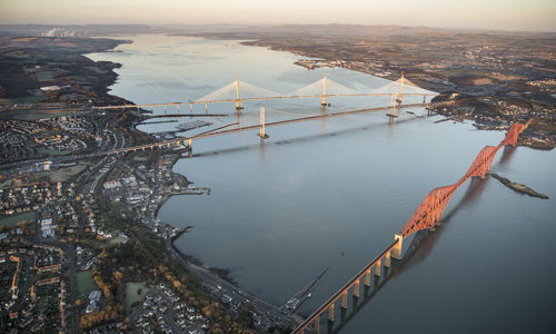 An aerial photograph of the three bridges over the Forth on a clear day