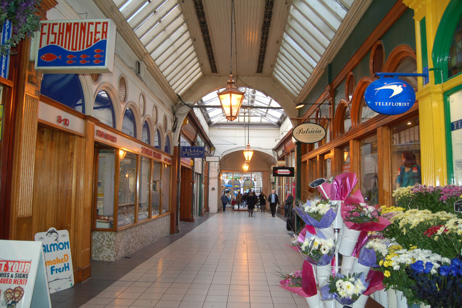 An arcade, with a tall, curved ceiling