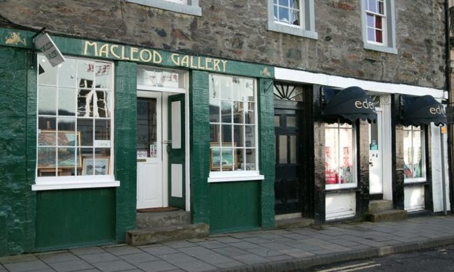 A row of traditional high street shops which are part of a stone building
