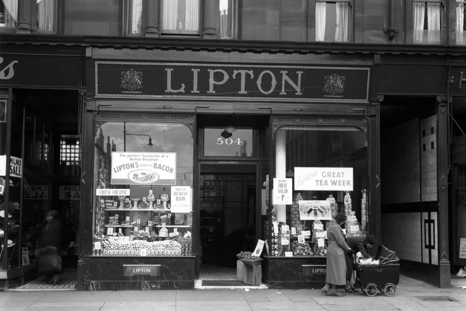 A shop with large, glass windows full of displays