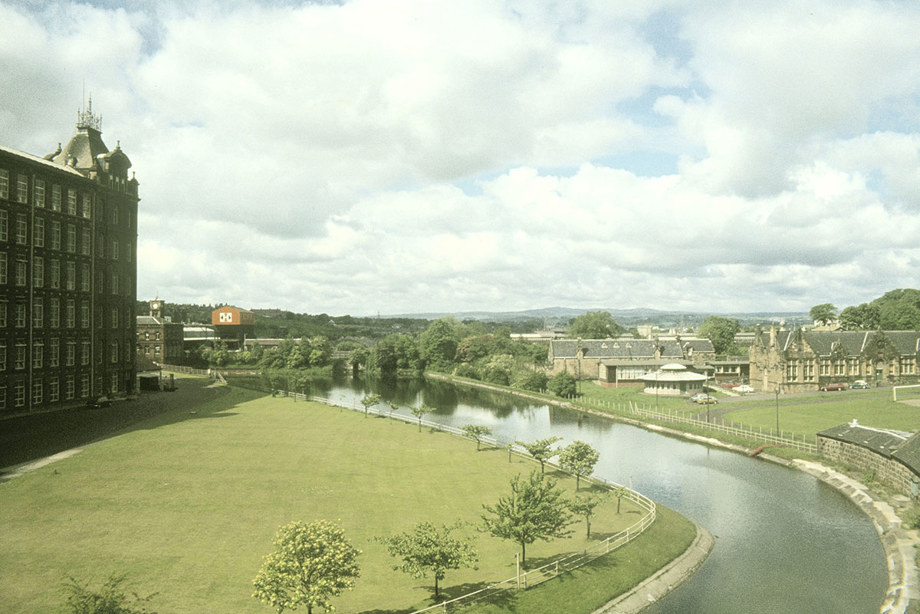 A large factory building by the side of a canal