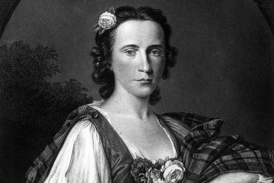 Flora MacDonald wearing tartan and a flower in her hair 