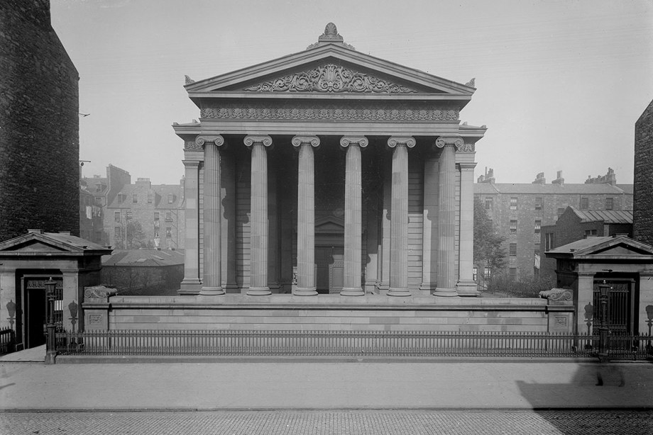A classical building with grand pillars and two entranceways.