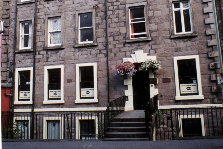 A Scottish four-storey building with a staircase leading into the entrance.