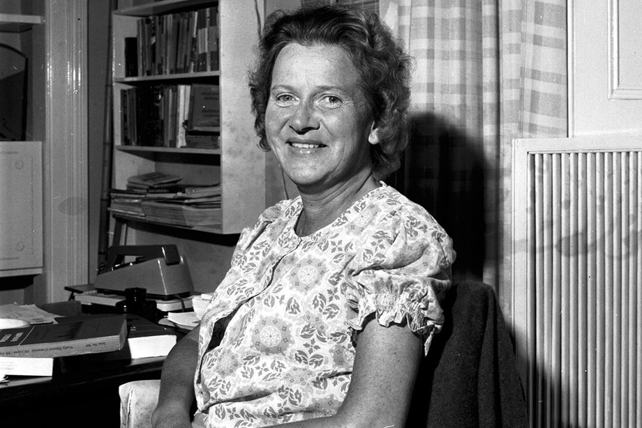 Dr Margaret Blackwood sitting in her wheelchair and smiling at the camera