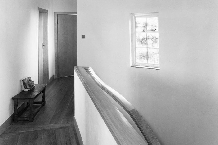 A stairwell of a brightly lit building with gentle curves and angles