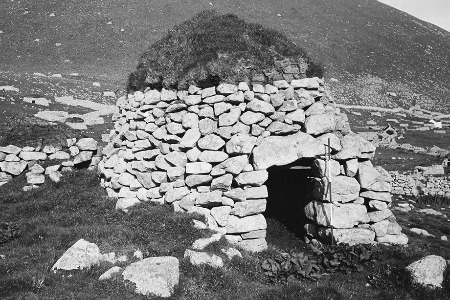 A stone-built monument with a grassy roof.