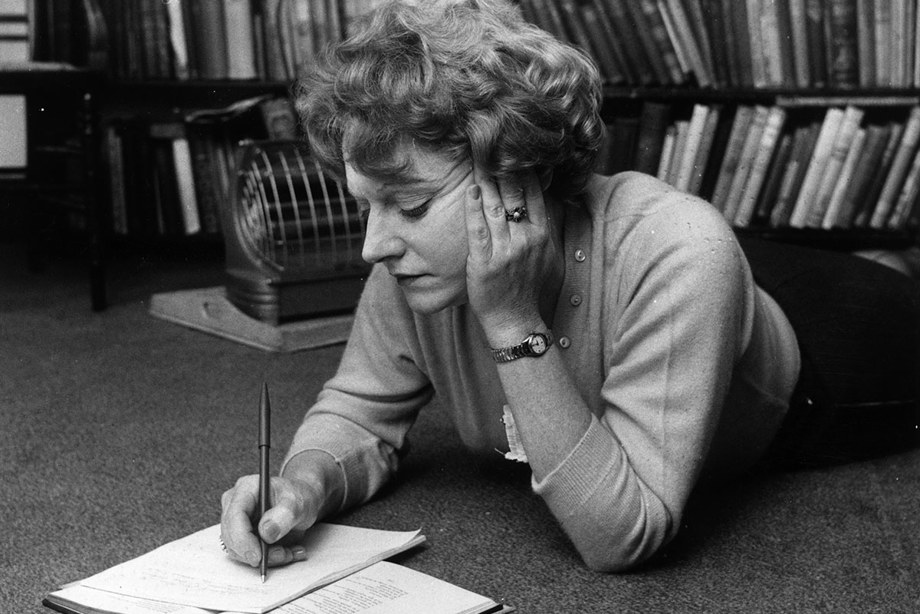  Muriel Spark making notes while lying on the floor.