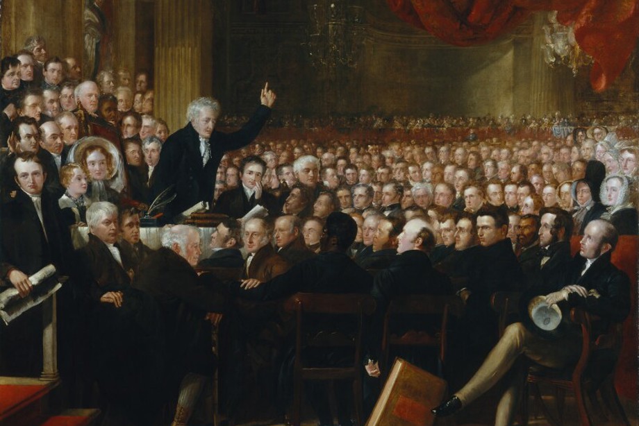 Painting of a large group of people in a grand room listening to a speaker. Only one woman is visible.