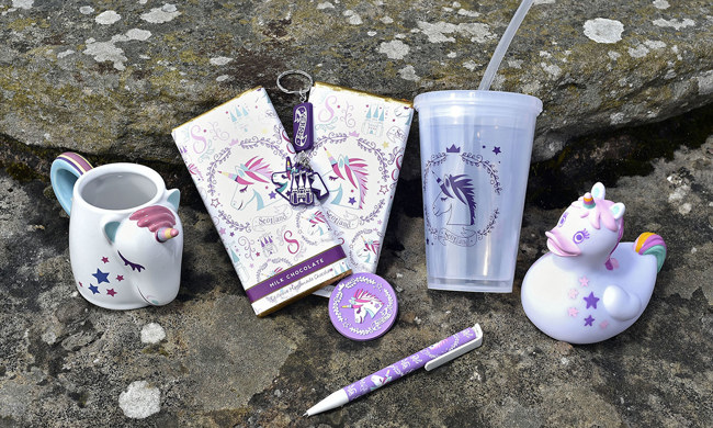A selection of products from our Unicorn gift range, including a mug, pen, chocolate, reusable cup & keyring